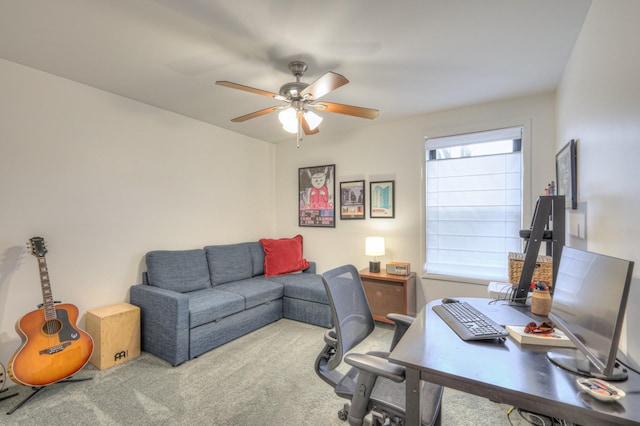 carpeted office space featuring ceiling fan