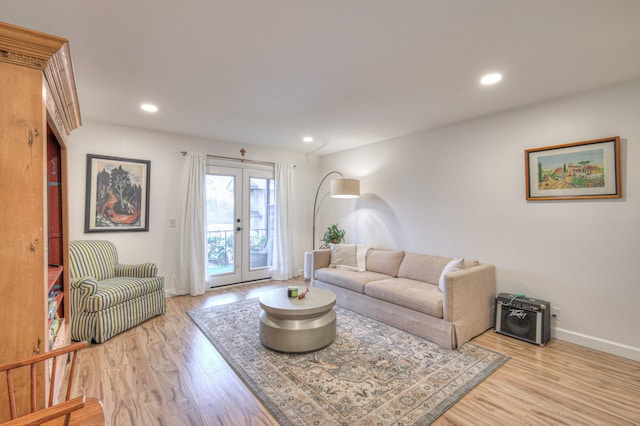 living room featuring french doors and light wood-type flooring