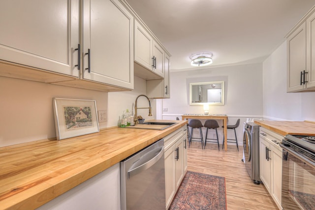 kitchen with wood counters, sink, electric range, and dishwasher