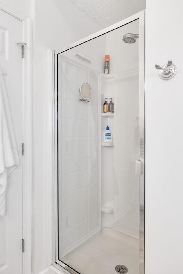 bathroom featuring a shower with shower door