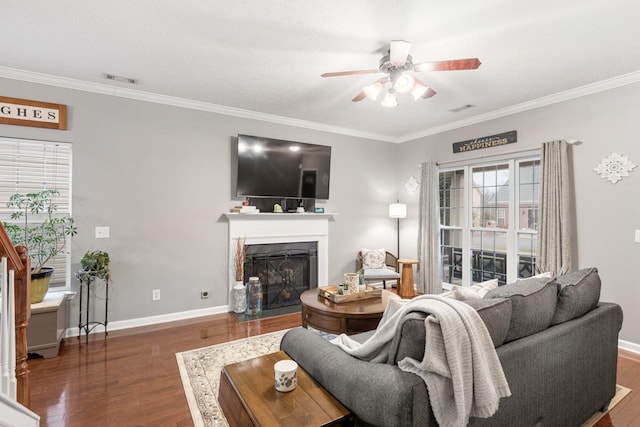 living room featuring crown molding, ceiling fan, and dark hardwood / wood-style flooring