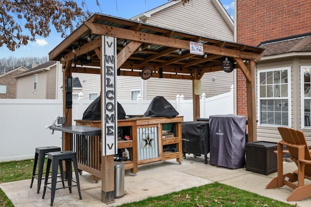 view of patio with area for grilling and an outdoor bar