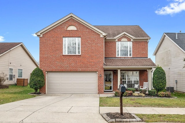 front of property with a garage, covered porch, and a front lawn