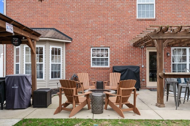 view of patio / terrace featuring area for grilling, a pergola, and a fire pit