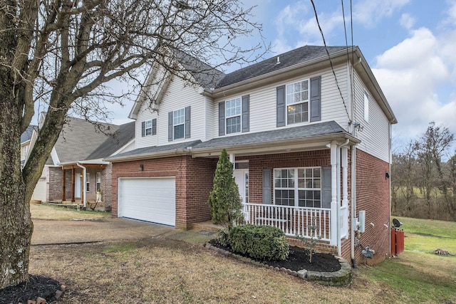 view of front of home featuring a garage, covered porch, and a front lawn