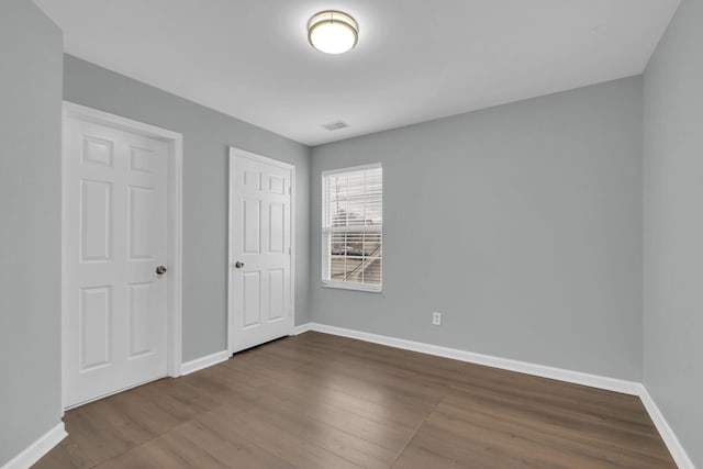 unfurnished bedroom with wood-type flooring