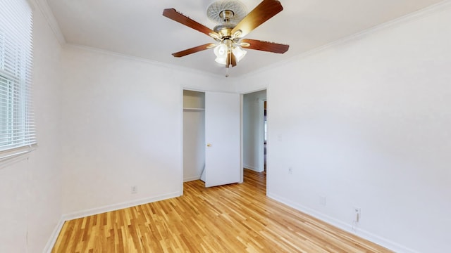 empty room featuring crown molding, ceiling fan, and light hardwood / wood-style floors