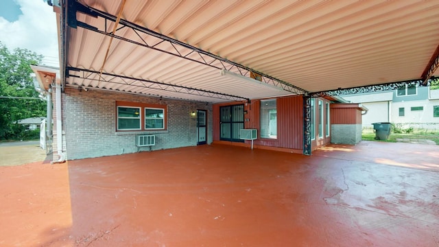 view of patio / terrace featuring a carport and a wall unit AC