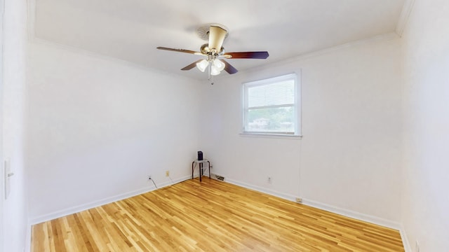 empty room with hardwood / wood-style flooring, ceiling fan, and ornamental molding