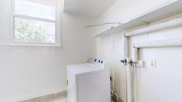 laundry room featuring washer / clothes dryer and a textured ceiling