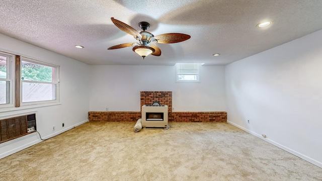 unfurnished room with ceiling fan, light carpet, and a textured ceiling