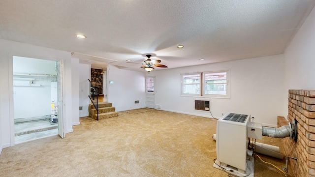 carpeted living room featuring heating unit, ceiling fan, a fireplace, and a textured ceiling