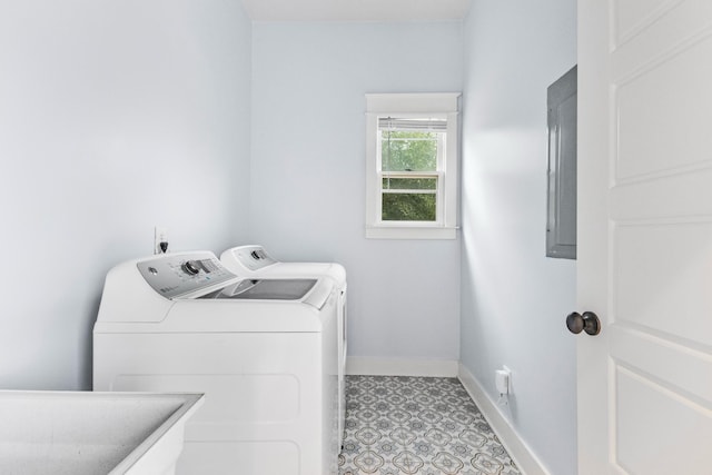 washroom featuring separate washer and dryer, sink, and electric panel