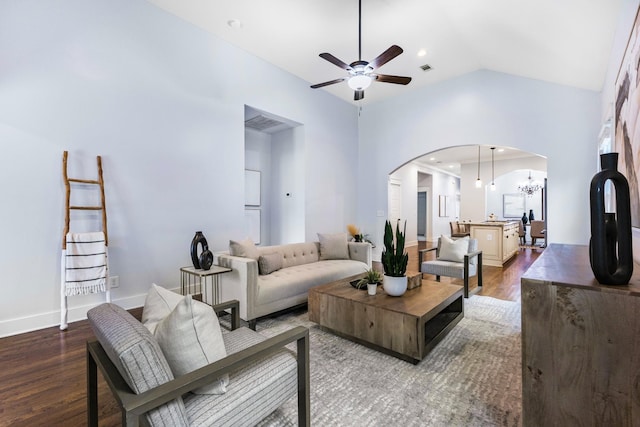 living room featuring hardwood / wood-style flooring, high vaulted ceiling, and ceiling fan with notable chandelier