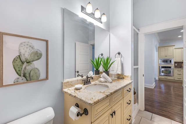 bathroom with vanity, crown molding, tile patterned floors, and toilet