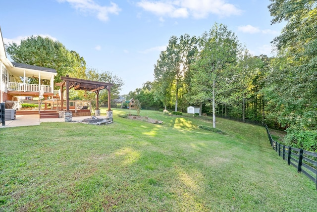 view of yard featuring a storage unit, a pergola, a deck, and a patio