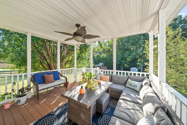 deck featuring ceiling fan, a storage shed, and an outdoor living space