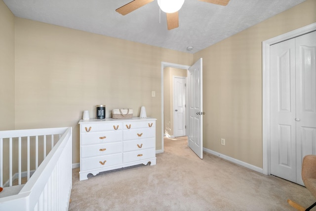 carpeted bedroom with a closet and ceiling fan