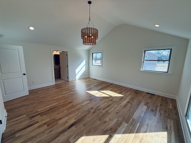 interior space with recessed lighting, baseboards, lofted ceiling, and wood finished floors