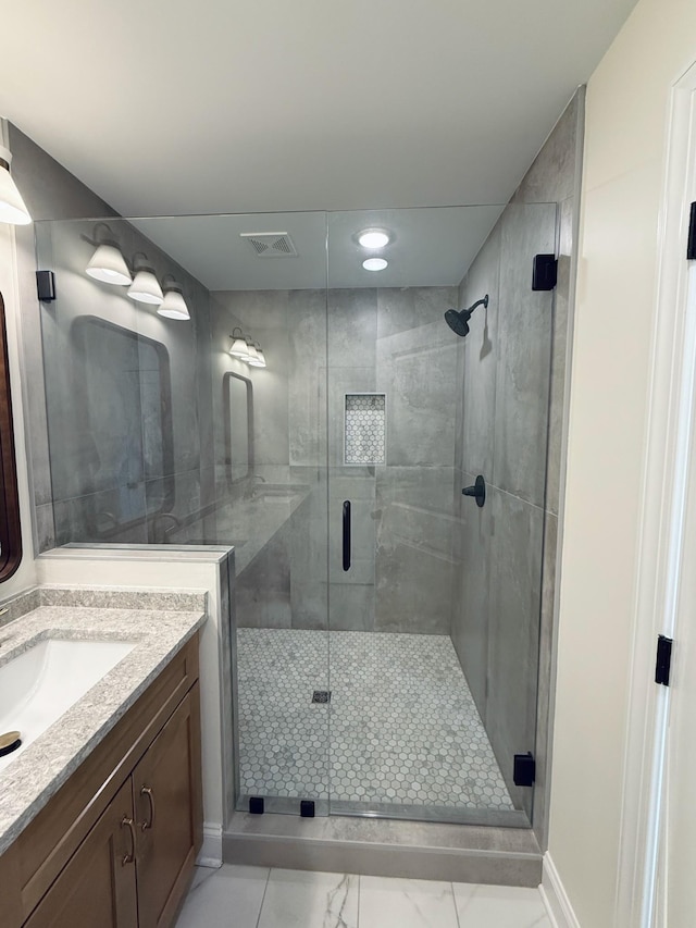 full bathroom with vanity, a shower stall, visible vents, and marble finish floor