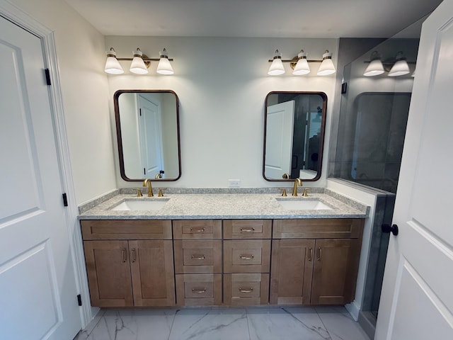 full bath featuring double vanity, marble finish floor, and a sink