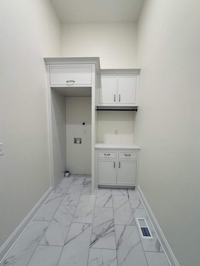 clothes washing area featuring cabinet space, visible vents, marble finish floor, and hookup for an electric dryer