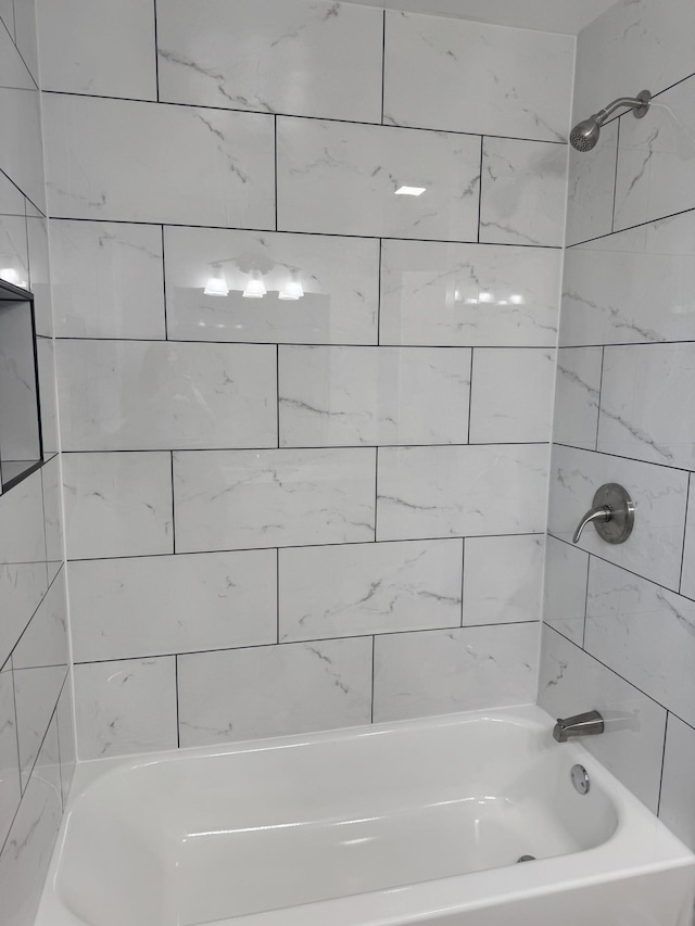 bathroom featuring tiled shower / bath