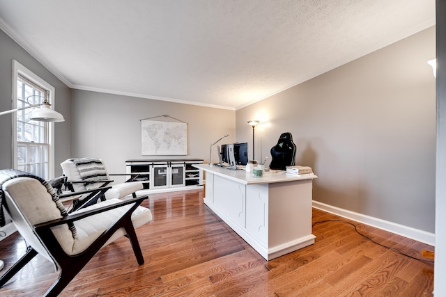 office area with crown molding, light hardwood / wood-style floors, and a textured ceiling