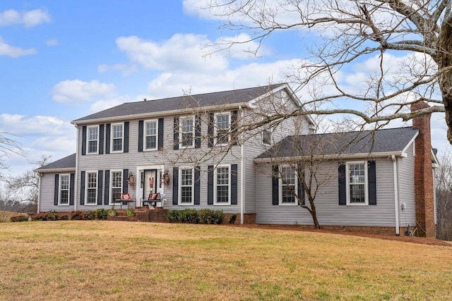 colonial home with a front yard