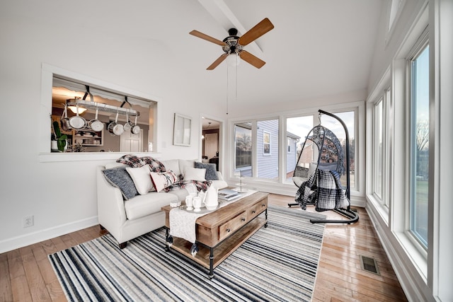 living room featuring wood-type flooring, high vaulted ceiling, and ceiling fan