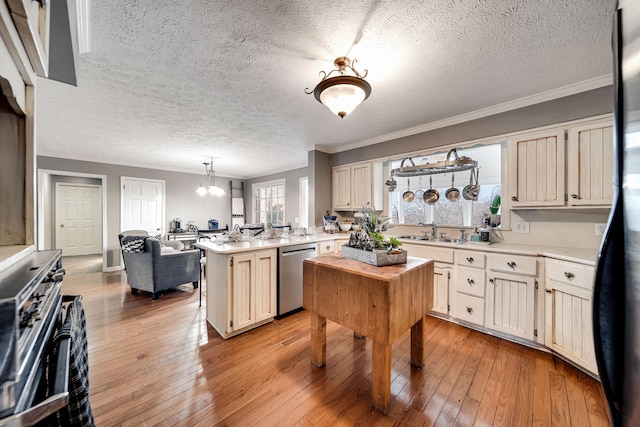 kitchen featuring hanging light fixtures, light hardwood / wood-style flooring, stainless steel dishwasher, and a center island