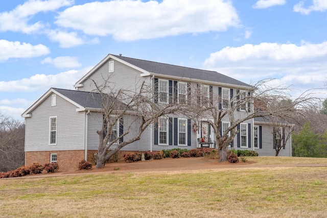 colonial inspired home with a front lawn