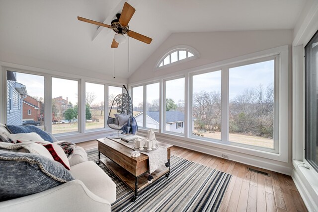 sunroom / solarium with ceiling fan and vaulted ceiling