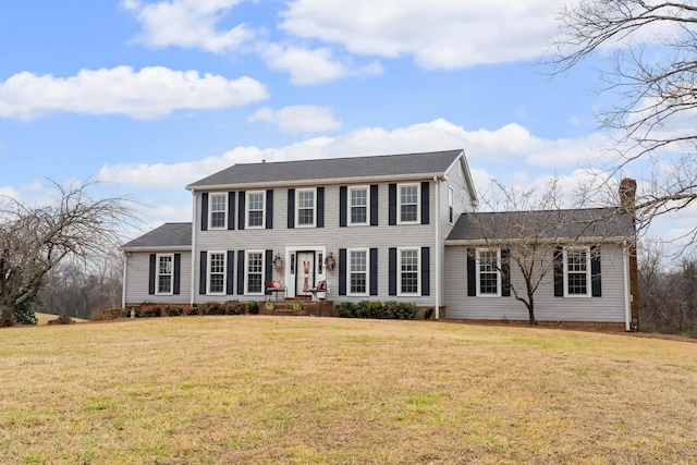 colonial inspired home with a front lawn