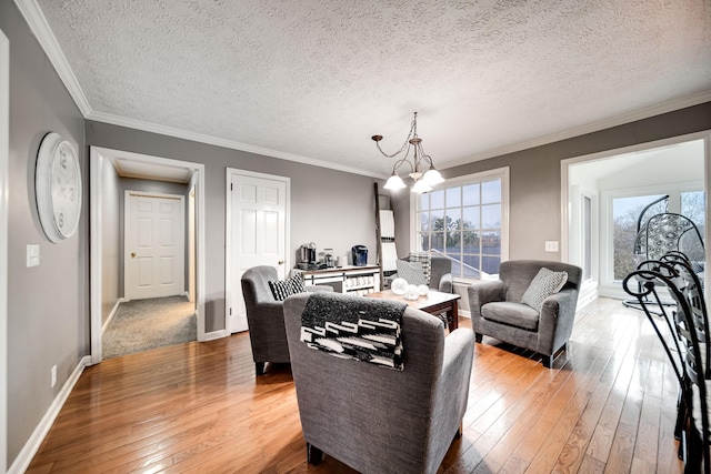 living room featuring ornamental molding, plenty of natural light, hardwood / wood-style floors, and a notable chandelier