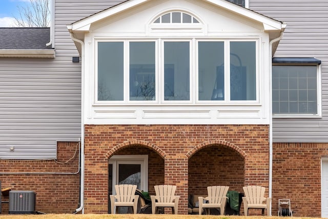 rear view of property with central AC