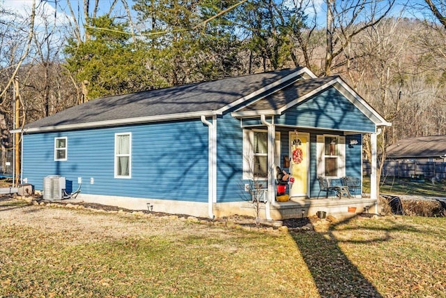 view of front of house featuring central AC, a front lawn, and a porch