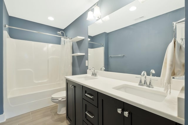 full bathroom featuring vanity, shower / bathtub combination with curtain, and toilet