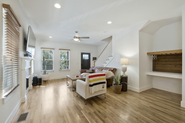 living room with ceiling fan and light wood-type flooring