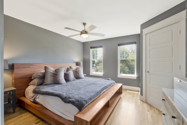 bedroom with ceiling fan and light hardwood / wood-style floors