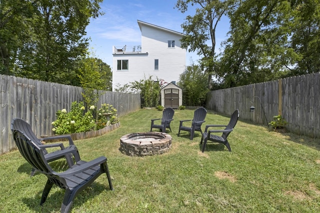 view of yard featuring a shed and a fire pit