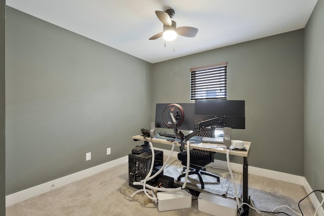 carpeted office space featuring ceiling fan