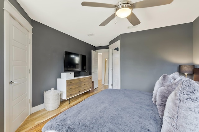 bedroom with ceiling fan and light hardwood / wood-style floors