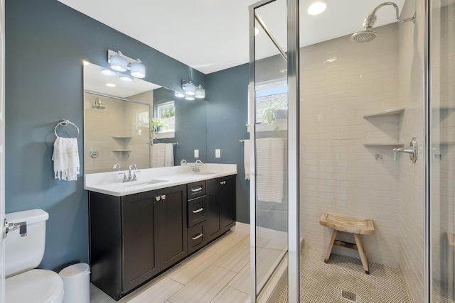 bathroom featuring vanity, toilet, and walk in shower