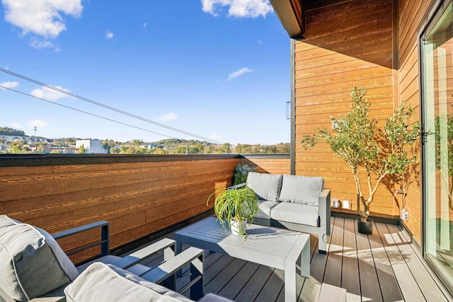 wooden terrace with outdoor lounge area