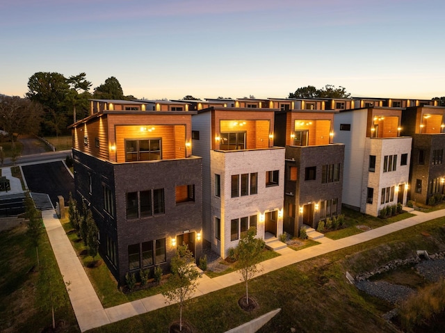 view of back house at dusk