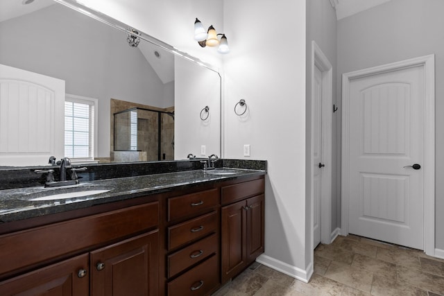 bathroom featuring walk in shower, vanity, and vaulted ceiling