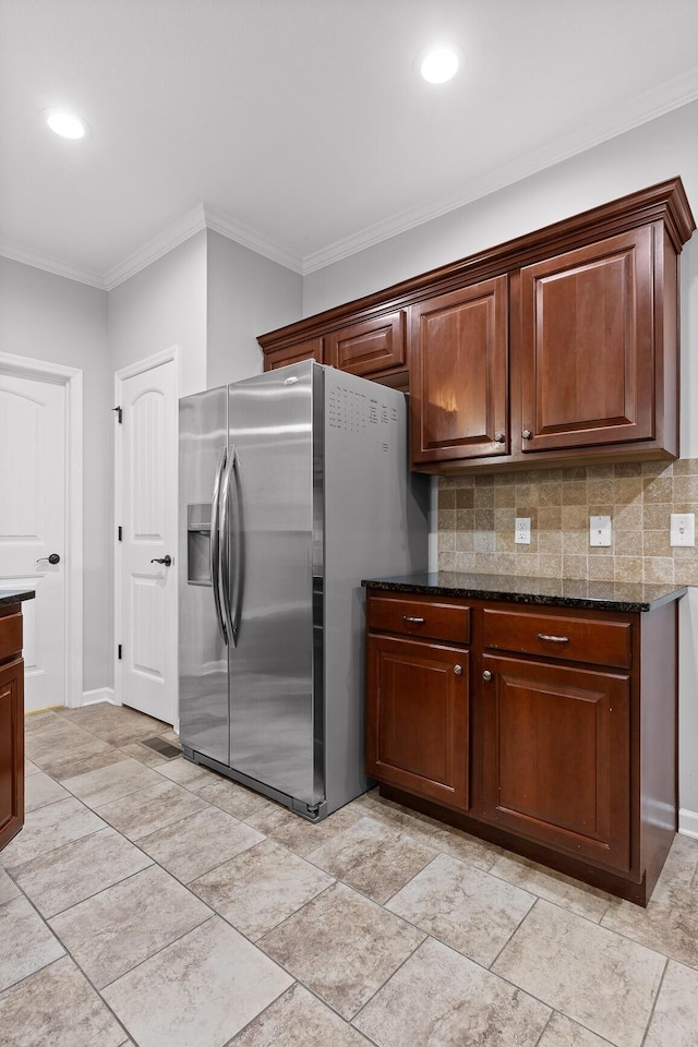 kitchen featuring crown molding, decorative backsplash, dark stone counters, and stainless steel fridge with ice dispenser