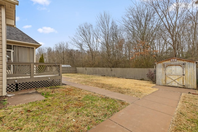 view of yard featuring a storage shed and a deck