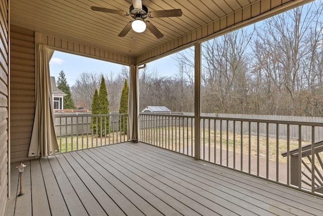 deck with a yard and ceiling fan